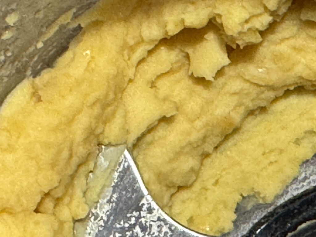 A close-up of fresh chickpea miso paste in a mixing bowl.